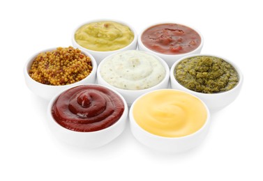 Many different sauces in bowls on white background