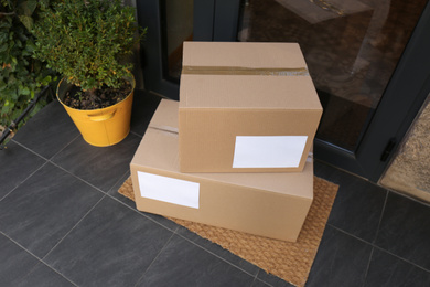 Photo of Delivered parcels on door mat near entrance, above view