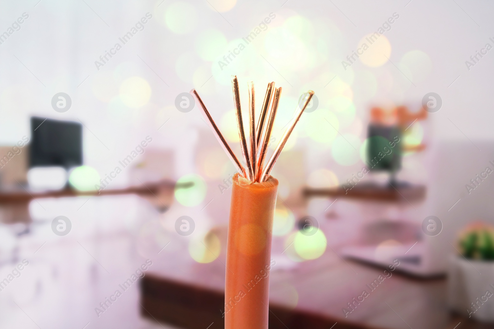 Image of One electrical wire against blurred background, closeup. Bokeh effect