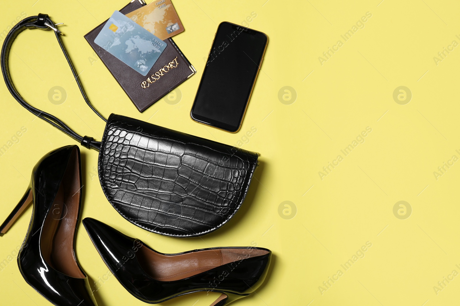 Photo of Flat lay composition with stylish woman's bag on yellow background. Space for text