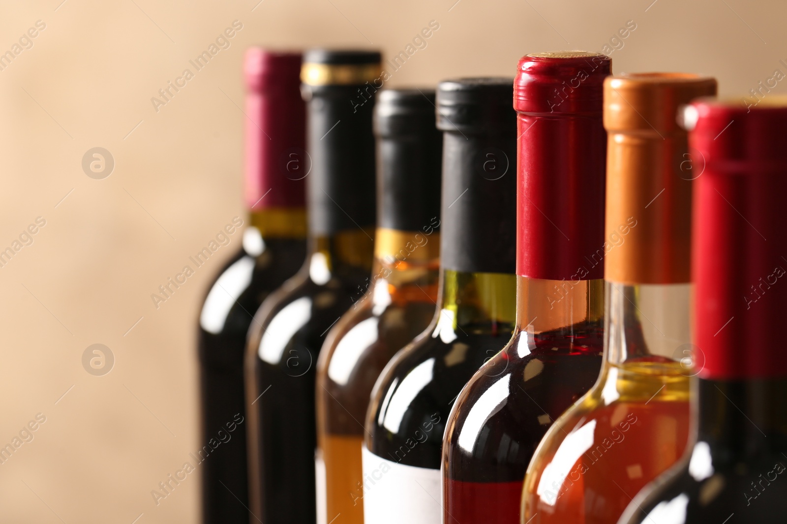 Photo of Bottles of different wines, closeup. Expensive collection