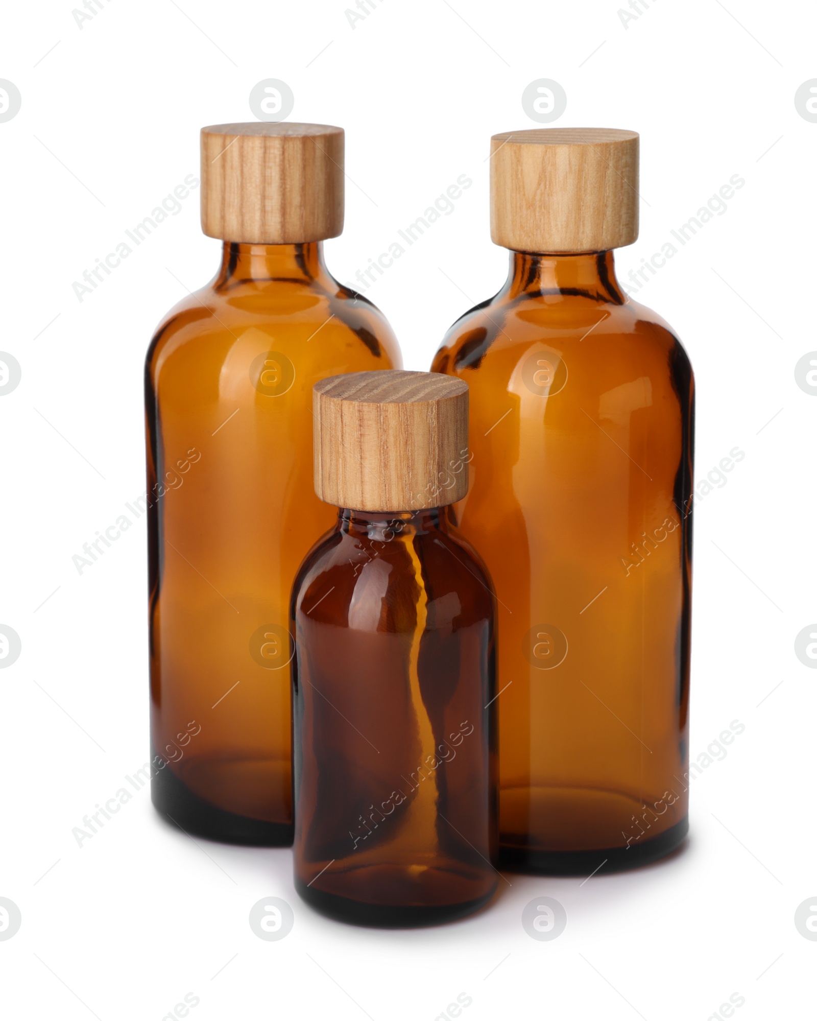 Photo of New empty glass bottles with wooden caps isolated on white