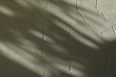 Photo of Light and shadows falling on textured wall