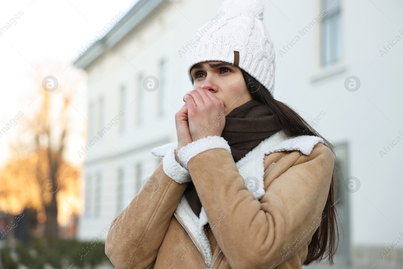 Photo of Sick young woman coughing outdoors. Cold symptom
