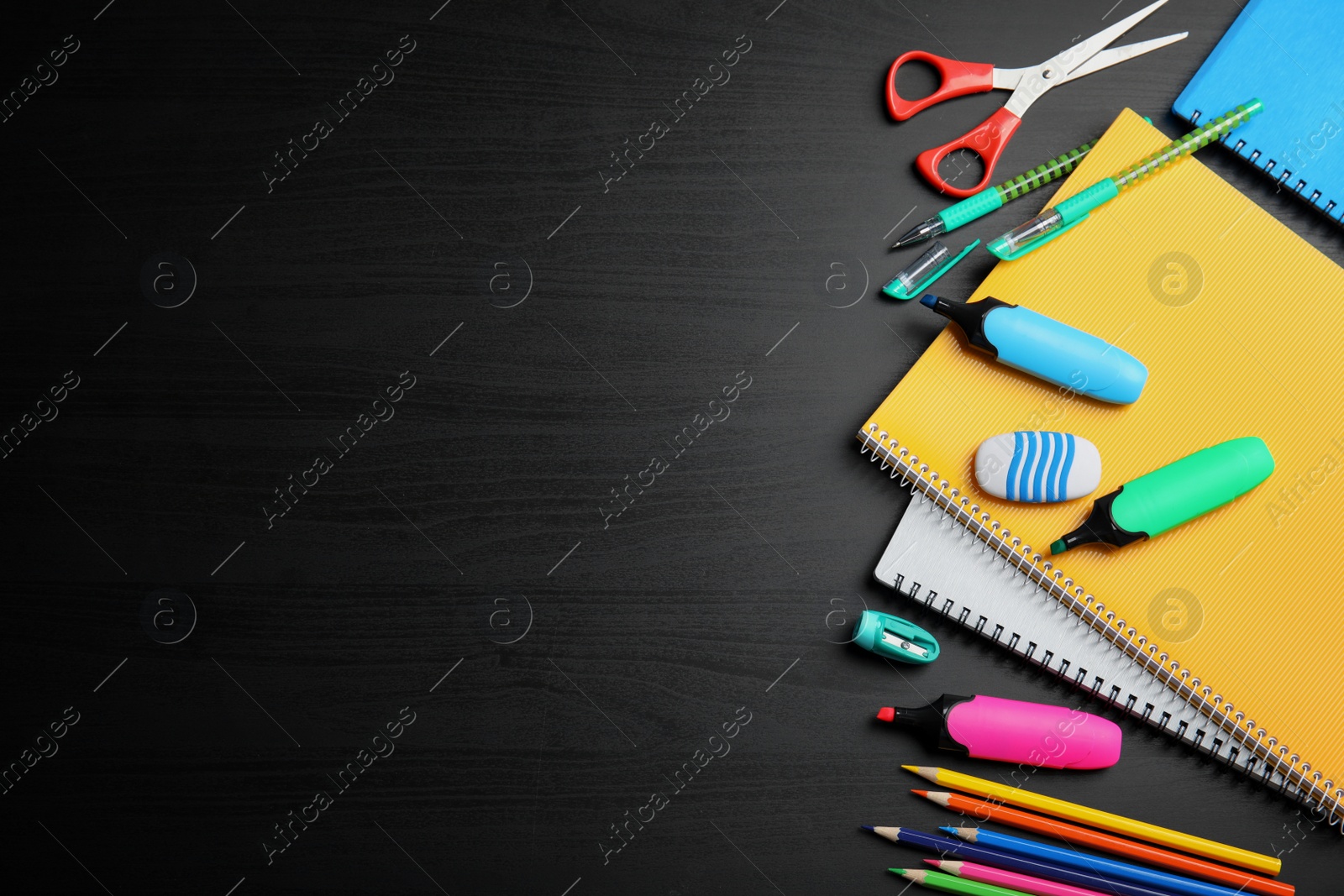 Photo of Different school stationery with space for design on wooden background, flat lay