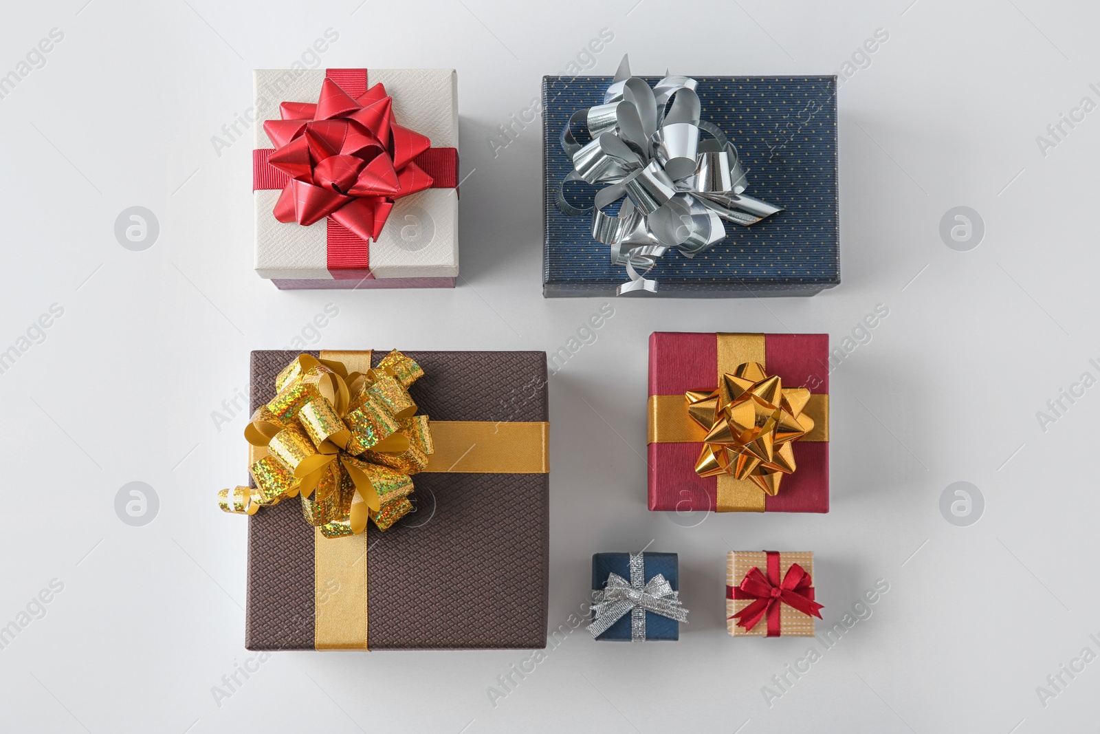 Photo of Beautiful gift boxes with bows on white background, top view