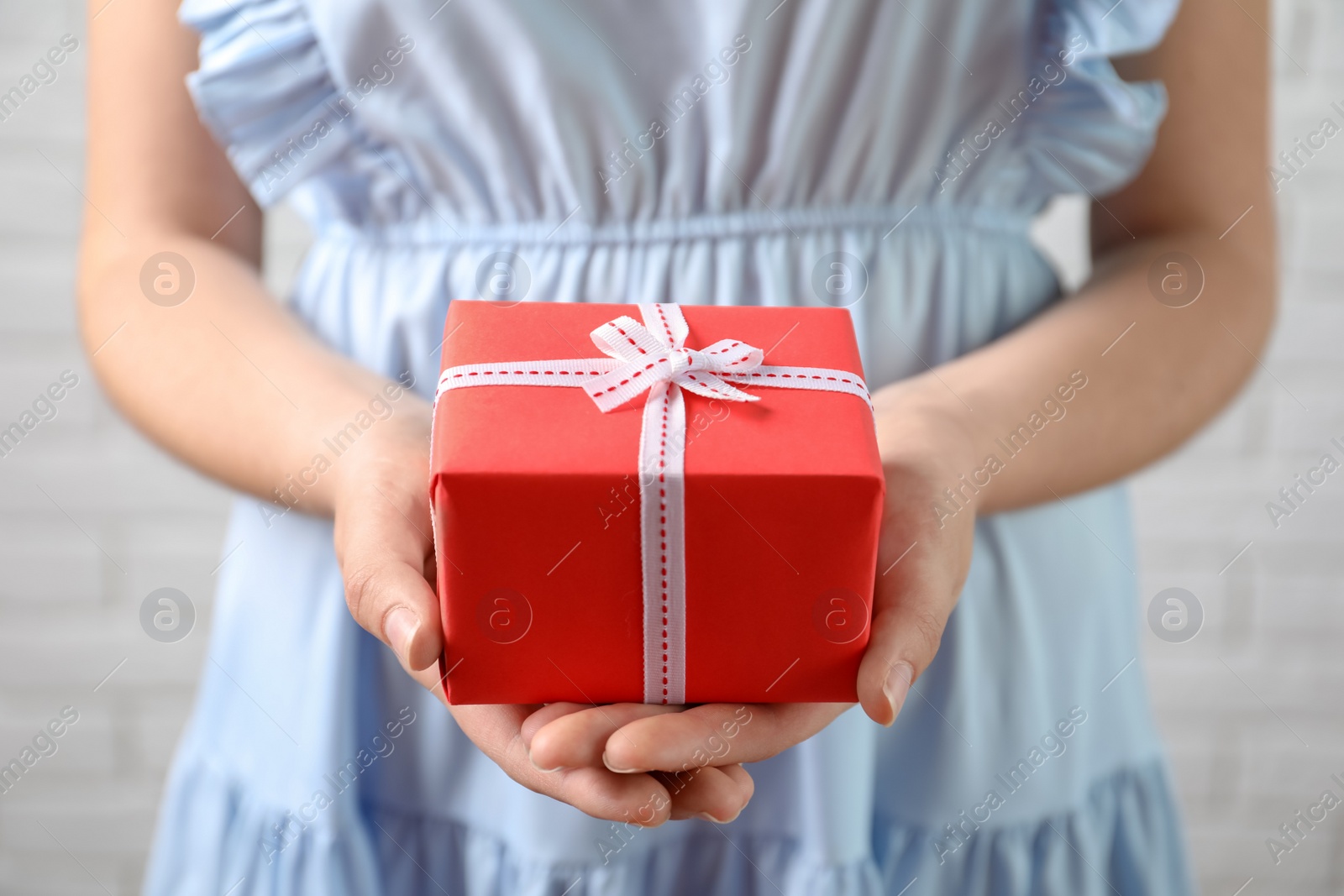 Photo of Woman holding beautiful gift box, closeup