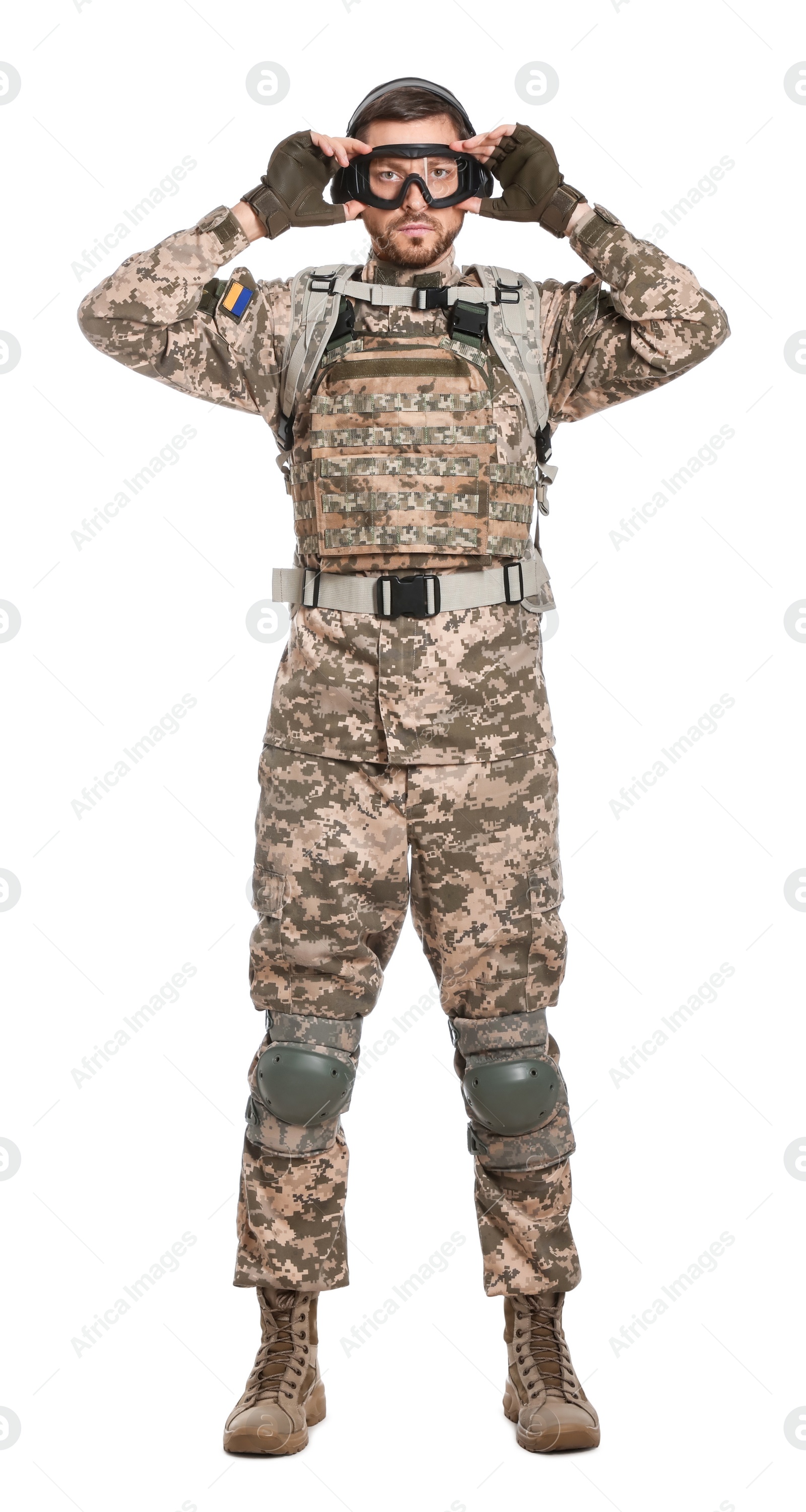 Photo of Soldier in Ukrainian military uniform, tactical goggles and headphones on white background