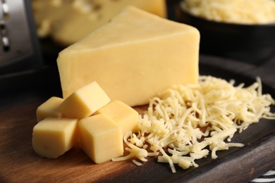 Grated and cut cheese on table, closeup