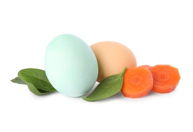Photo of Naturally painted Easter eggs on white background. Carrot and spinach used for coloring