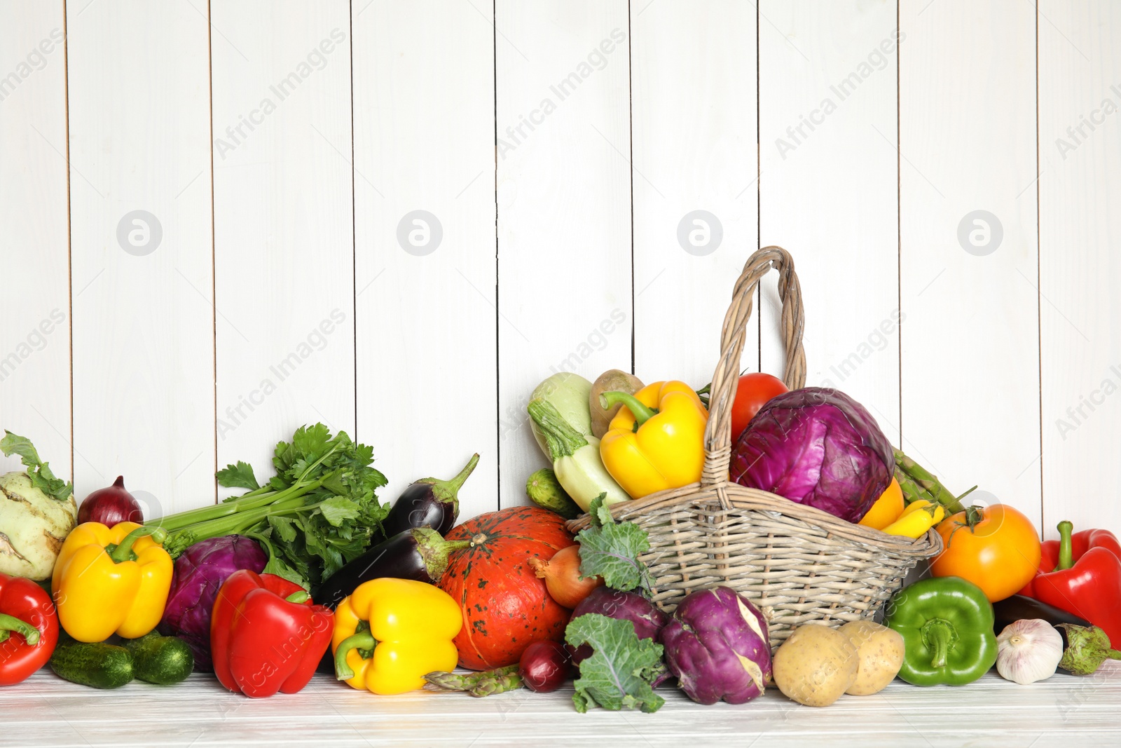 Photo of Many fresh ripe vegetables on wooden background. Organic food