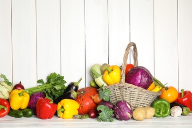 Photo of Many fresh ripe vegetables on wooden background. Organic food
