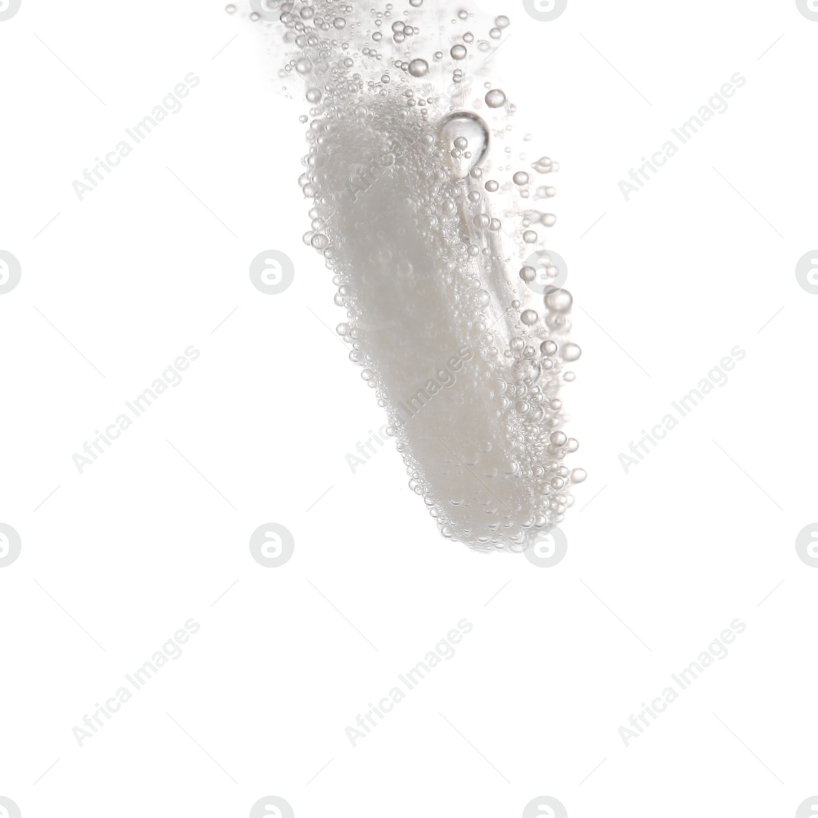 Photo of Effervescent pill dissolving in water on white background, closeup