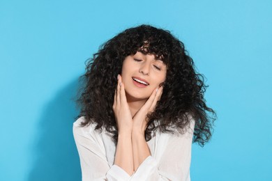 Photo of Portrait of beautiful young woman on light blue background