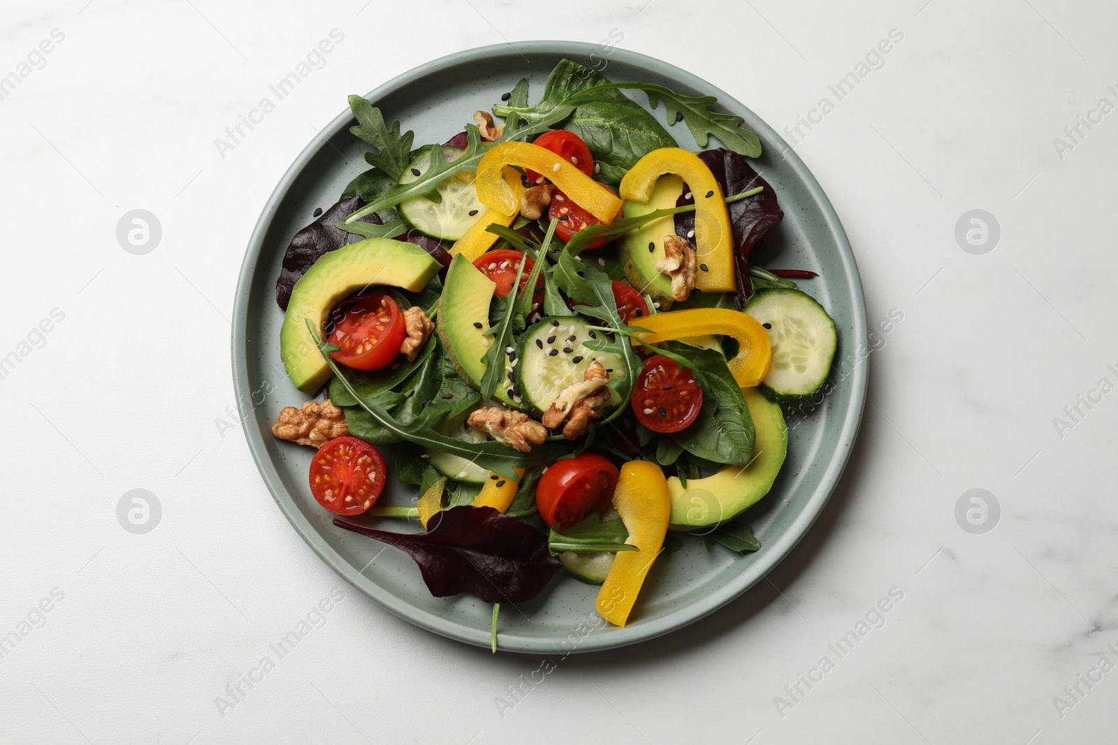 Photo of Balanced diet and vegetarian foods. Plate with different delicious products on white marble table, top view