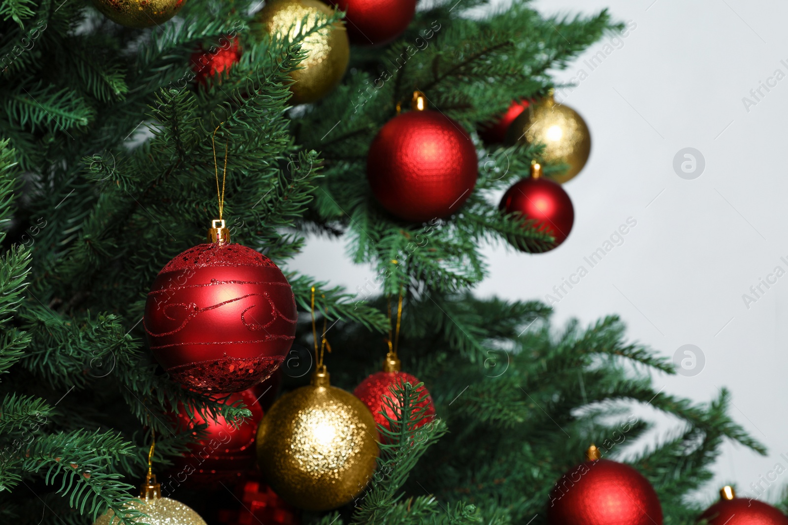 Photo of Beautiful Christmas tree with shiny baubles on white background, closeup