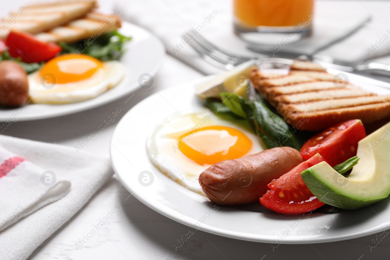 Photo of Delicious breakfast with fried eggs served on white table, closeup