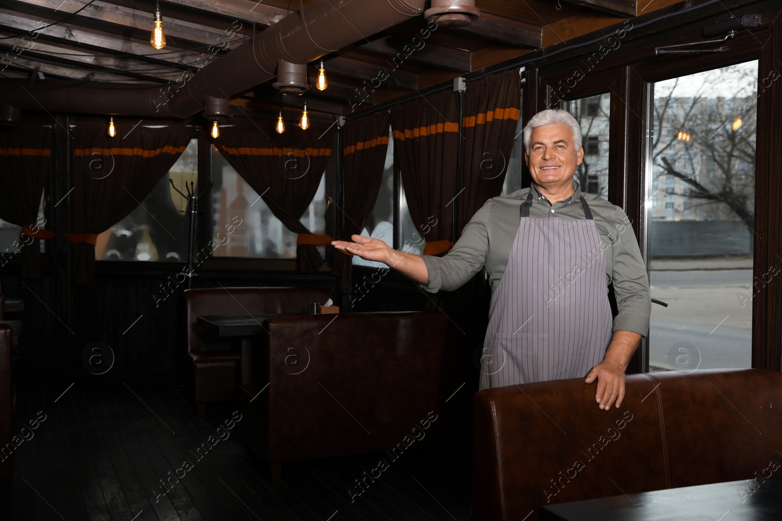 Photo of Senior male business owner in his restaurant