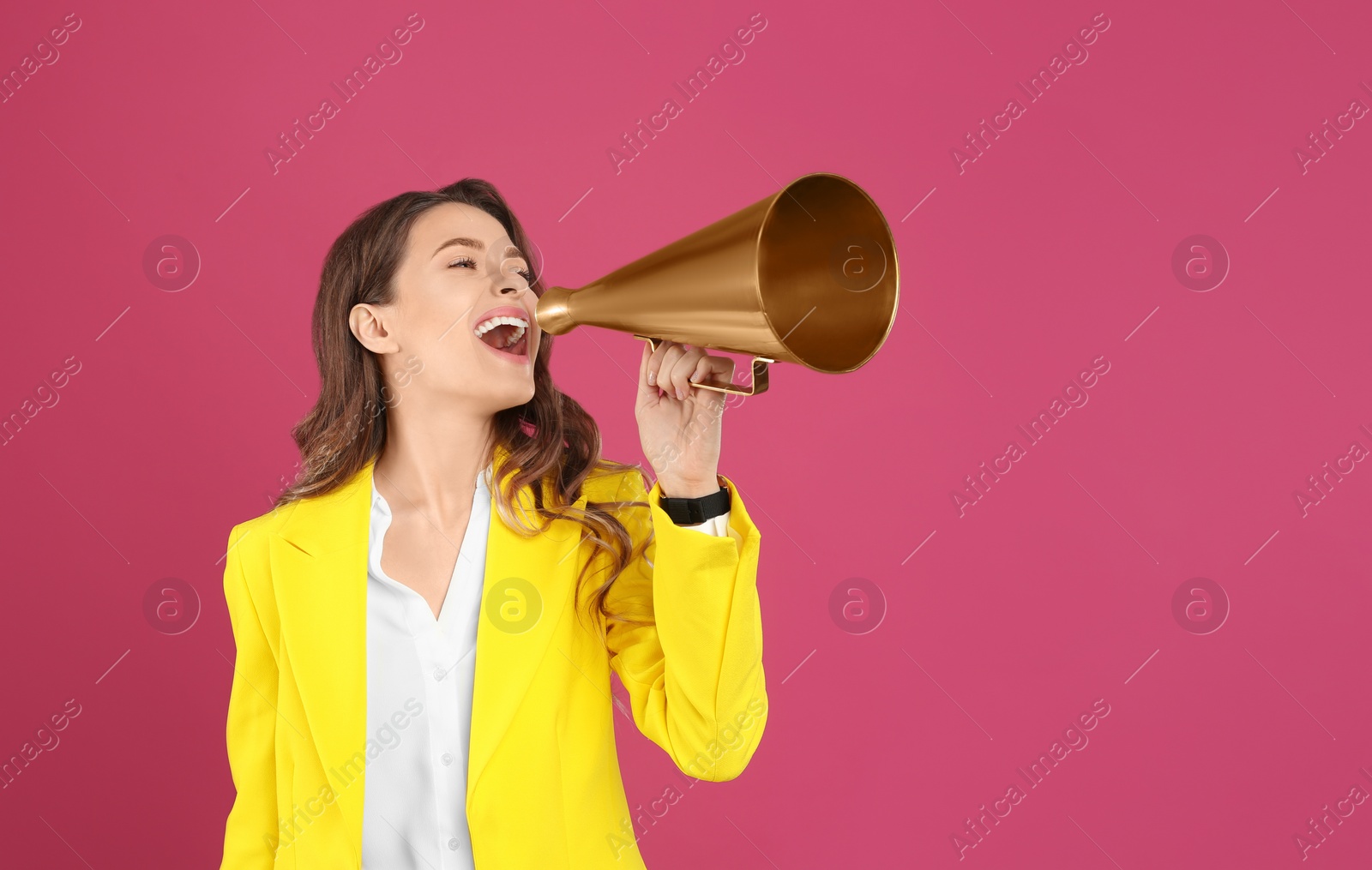 Photo of Young woman with megaphone on pink background