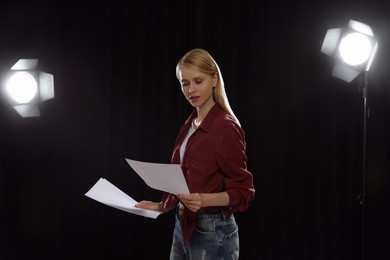 Photo of Professional actress reading her script during rehearsal in theatre