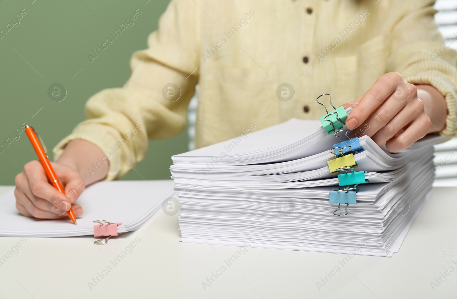 Photo of Woman signing documents at table in office, closeup