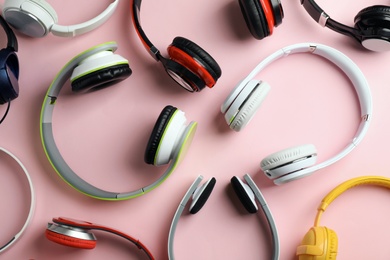 Photo of Many different headphones on color background, top view