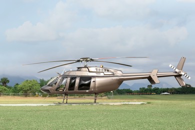 Beautiful modern helicopter on helipad in field