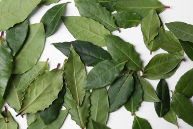 Photo of Many fresh bay leaves on white background, flat lay