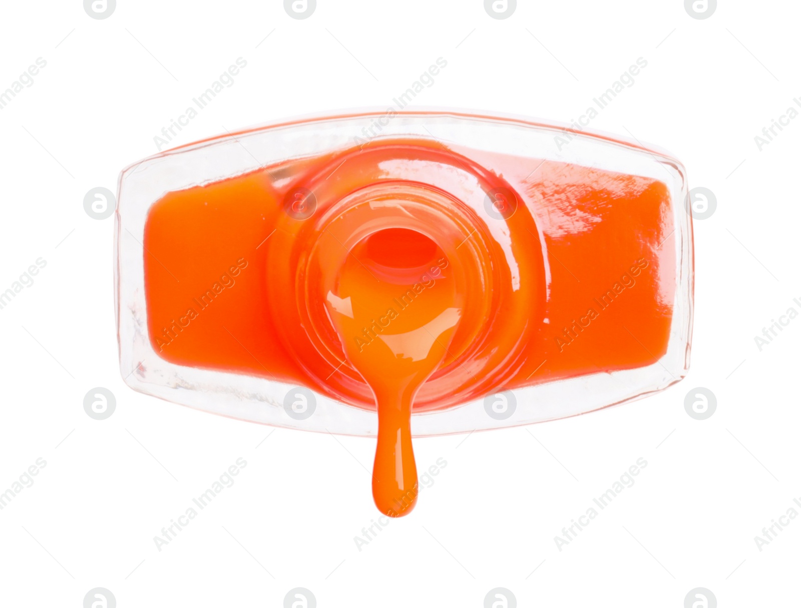 Photo of Orange nail polish dripping from bottle isolated on white