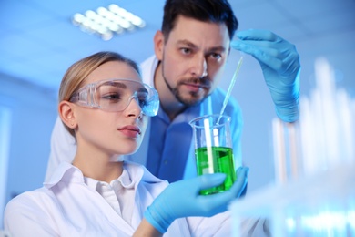 Scientists working with sample in chemistry laboratory