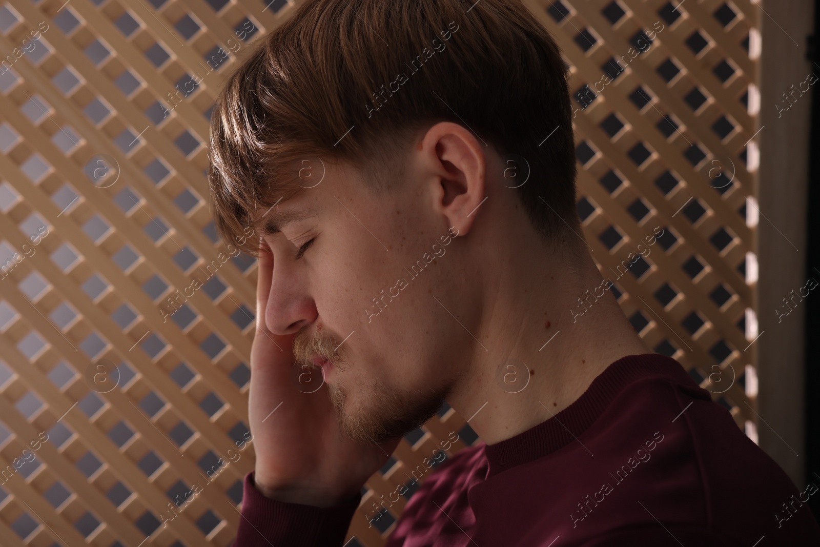 Photo of Upset young man during confession in church