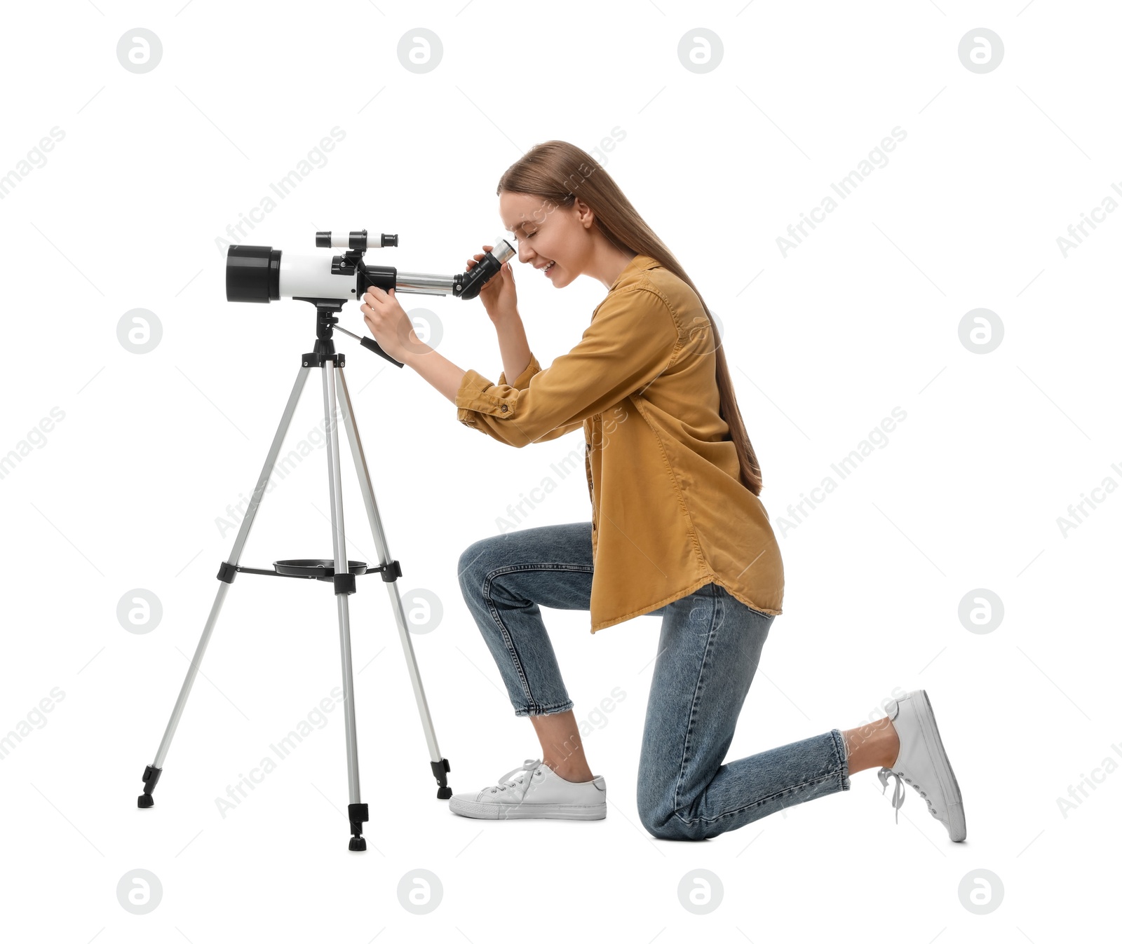 Photo of Young astronomer looking at stars through telescope on white background