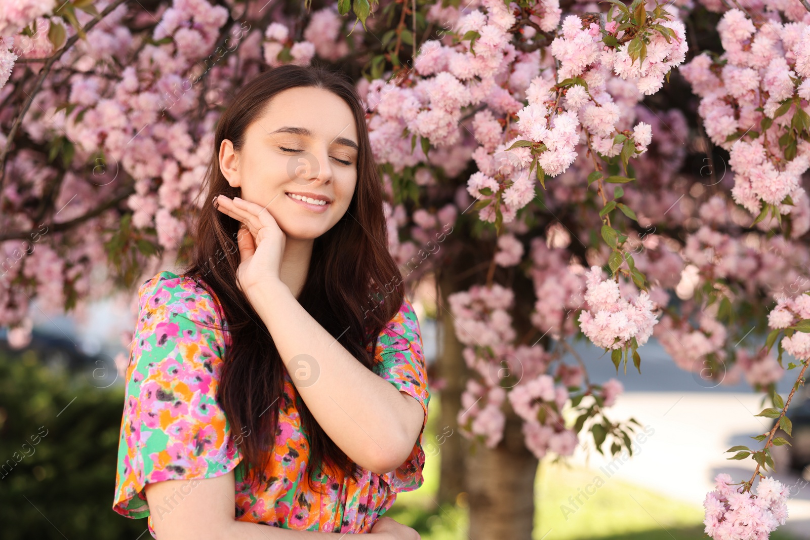 Photo of Beautiful woman near blossoming tree on spring day