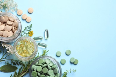 Photo of Different pills, herbs and flowers on light blue background, flat lay with space for text. Dietary supplements