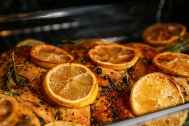 Delicious lemon chicken in oven, closeup view