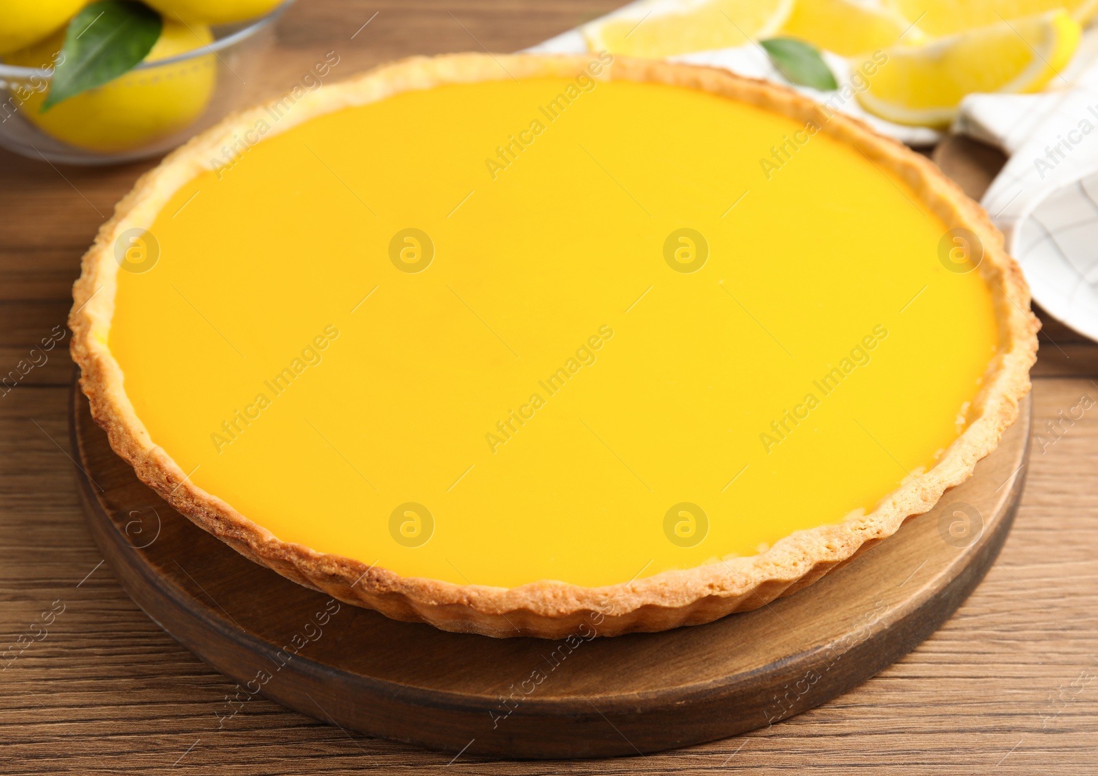 Photo of Delicious homemade lemon pie on wooden table, closeup