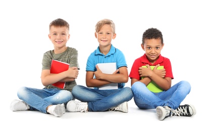 Photo of Group of little children with school supplies on white background