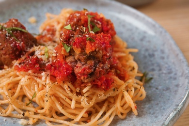 Delicious pasta with meatballs and tomato sauce on plate, closeup