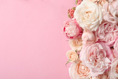 Photo of Flat lay composition with beautiful roses and space for text on color background