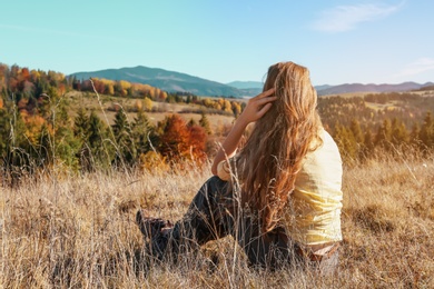 Female traveler viewing peaceful mountain landscape