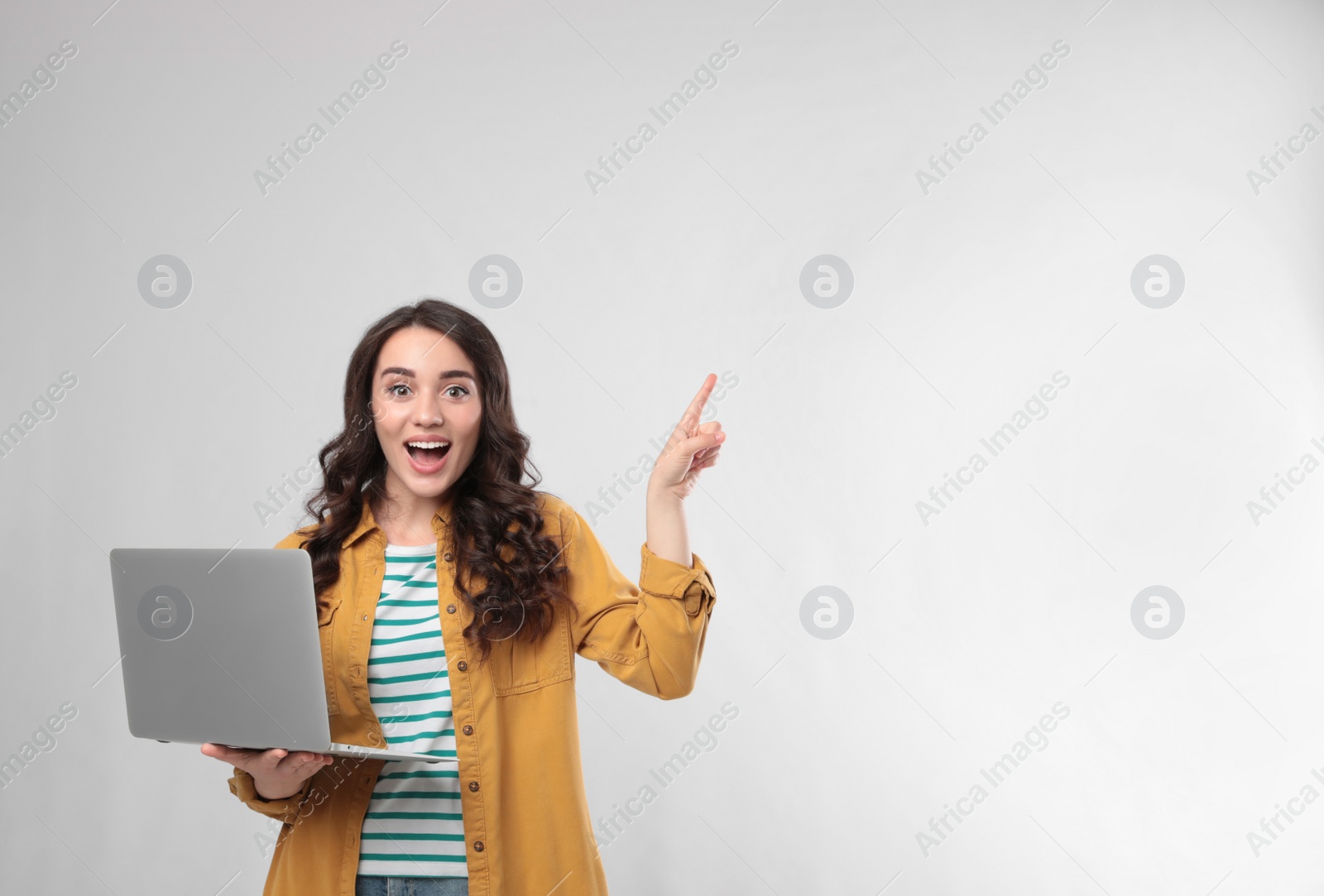 Photo of Young woman with laptop on white background