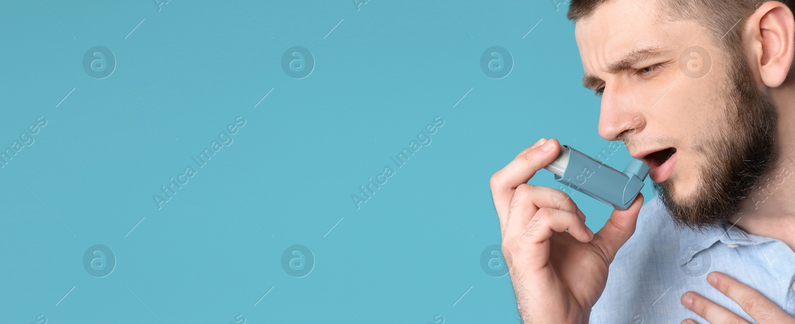 Image of Man using asthma inhaler on blue background, space for text. Banner design