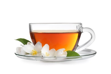 Glass cup of aromatic jasmine tea and fresh flowers on white background