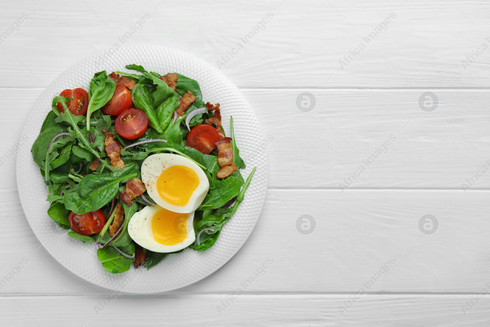 Photo of Delicious salad with boiled egg, bacon and tomatoes on white wooden table, top view. Space for text