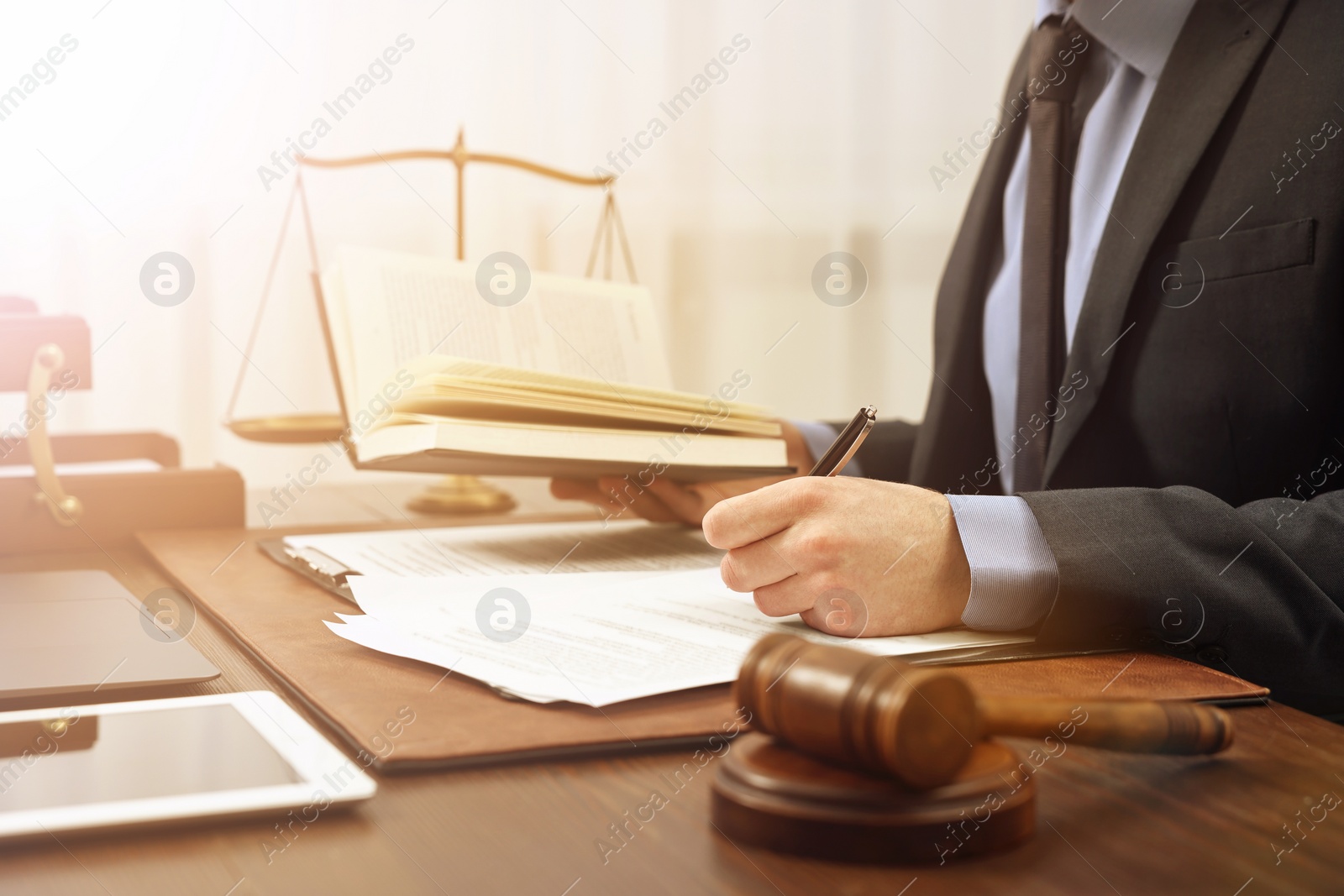 Image of Lawyer working with documents at wooden table in office, closeup