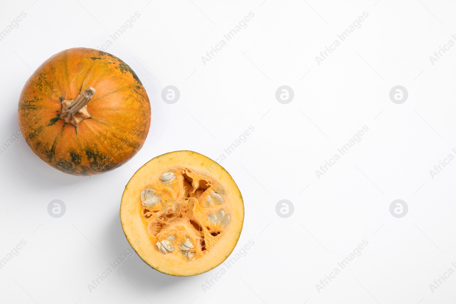 Photo of Fresh ripe pumpkins on white background, top view. Holiday decoration