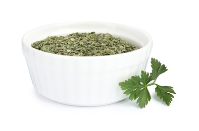 Photo of Bowl with dried parsley and fresh twig on white background
