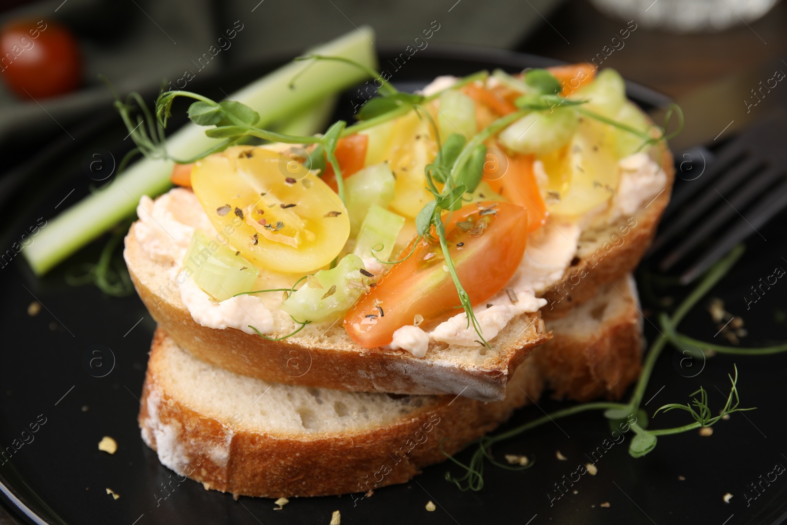 Photo of Tasty vegan sandwich with tomatoes, celery and microgreens on plate, closeup