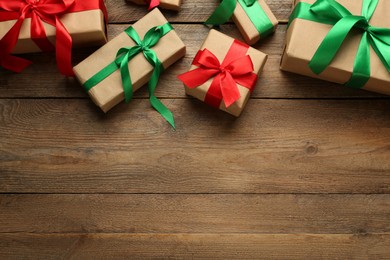 Photo of Many gift boxes on wooden table, flat lay. Space for text