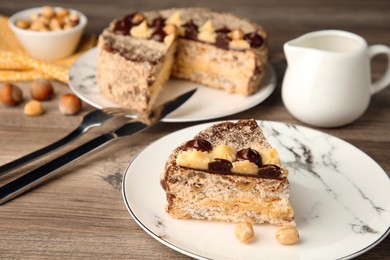 Photo of Piece of delicious Kyiv Cake served on wooden table, selective focus. Space for text